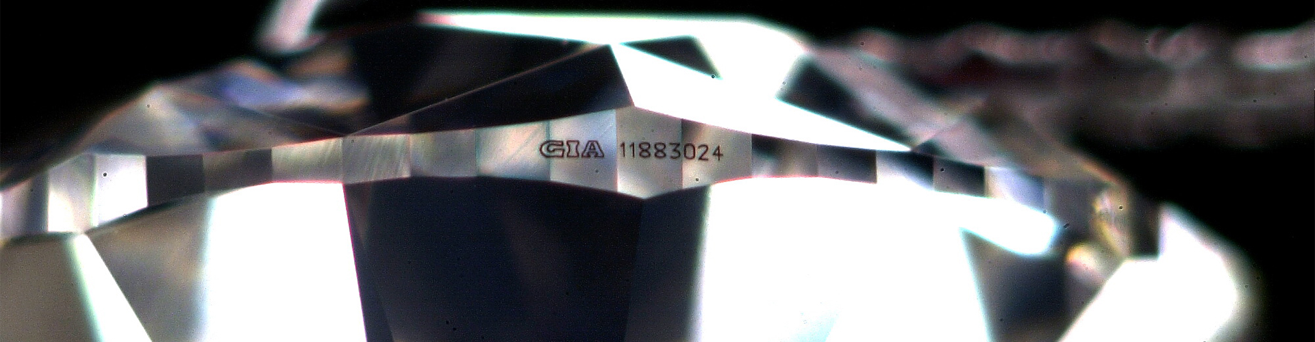 A diamond with a Gemmological Institute of America (GIA) report number laser inscribed on it.